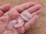 Rose quartz crystal angel wing pendant with carved angel wing design, gemstone jewelry charm featuring a hole for necklace attachment.