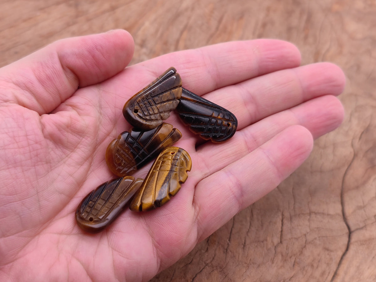 Tiger Eye Angel Wing crystal pendant with hole charm, showcasing polished gemstone and detailed angel wing design from GemstoneGO.