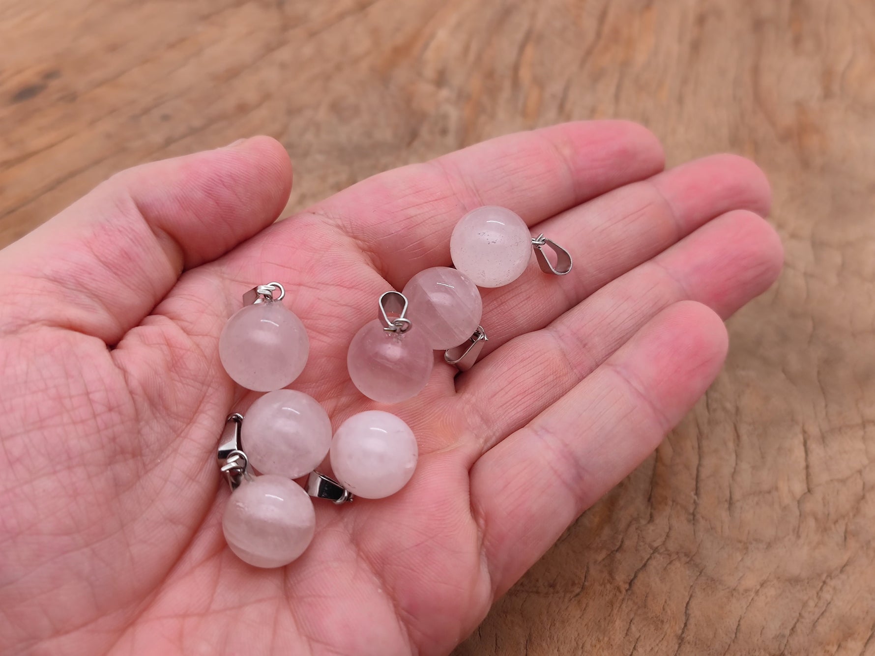 Rose quartz crystal ball pendant with a smooth round shape, ideal for jewelry making by GemstoneGO.