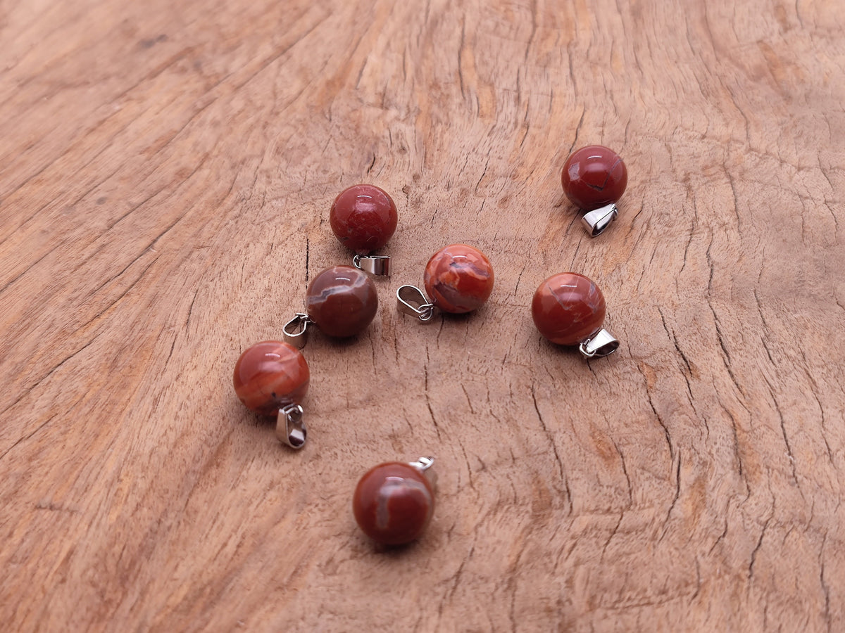 Red Jasper ball crystal pendant from GemstoneGO, showcasing a smooth round gemstone jewelry making accessory.