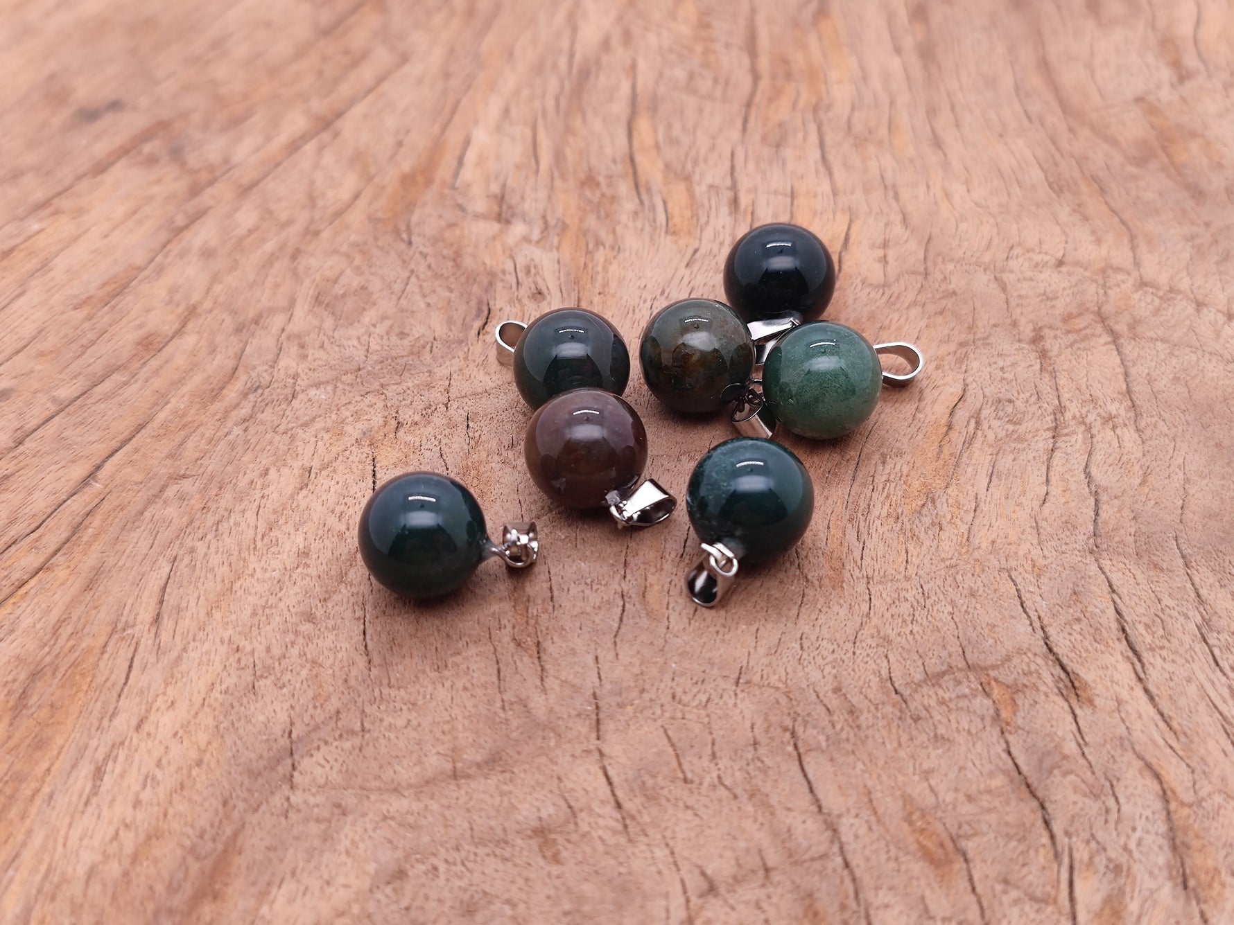 Moss agate round crystal pendant with natural green and brown patterns, perfect for jewelry making, by GemstoneGO.