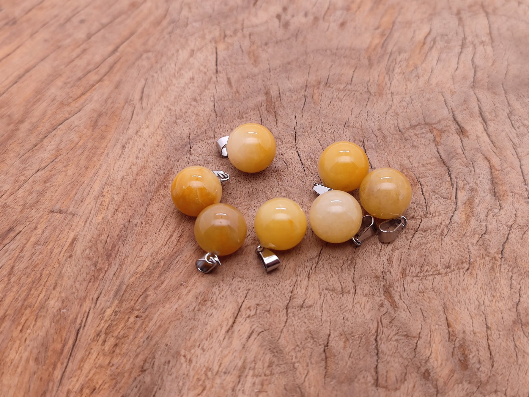 Yellow jade crystal ball pendant from GemstoneGO, round gemstone jewelry making pendant with polished smooth surface.