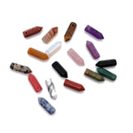 Drilled crystal point pendant with point hole design, featuring a healing gemstone bead, displayed in natural light.