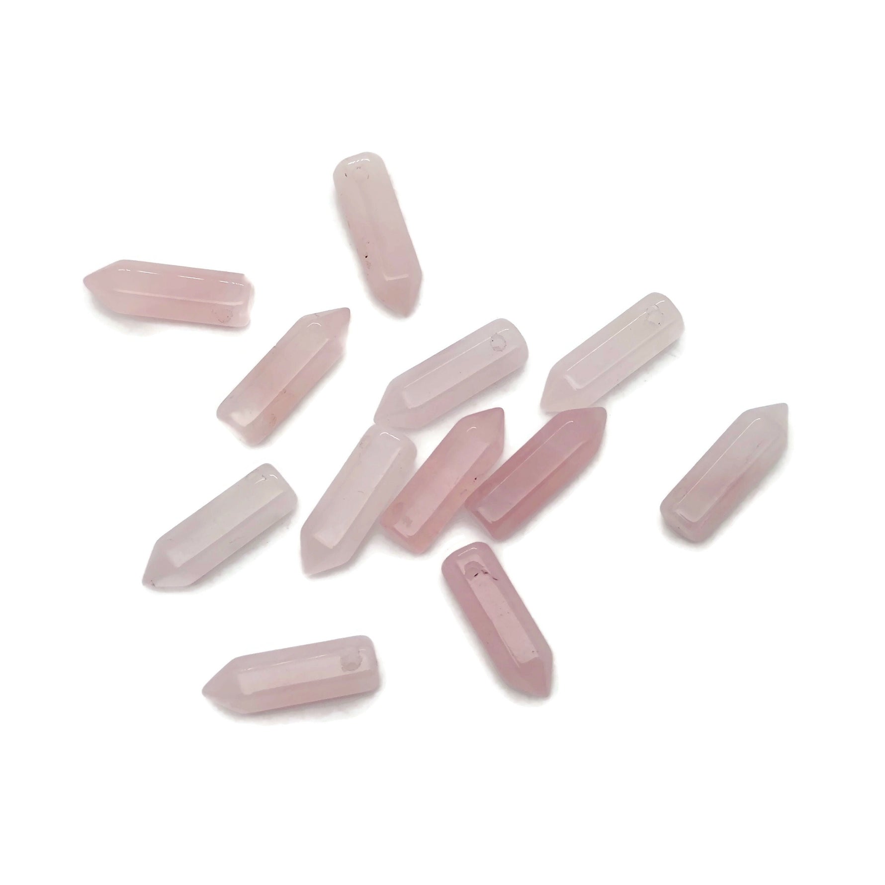 Rose quartz point crystal pendant with drilled hole, showcasing a polished pink gemstone from GemstoneGO.