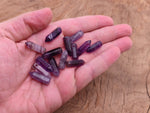 Amethyst point hole crystal pendant from GemstoneGO showing a drilled purple amethyst crystal with natural facets