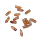 Carnelian point crystal pendant with drilled hole, showcasing rich orange-red gemstone from GemstoneGO.
