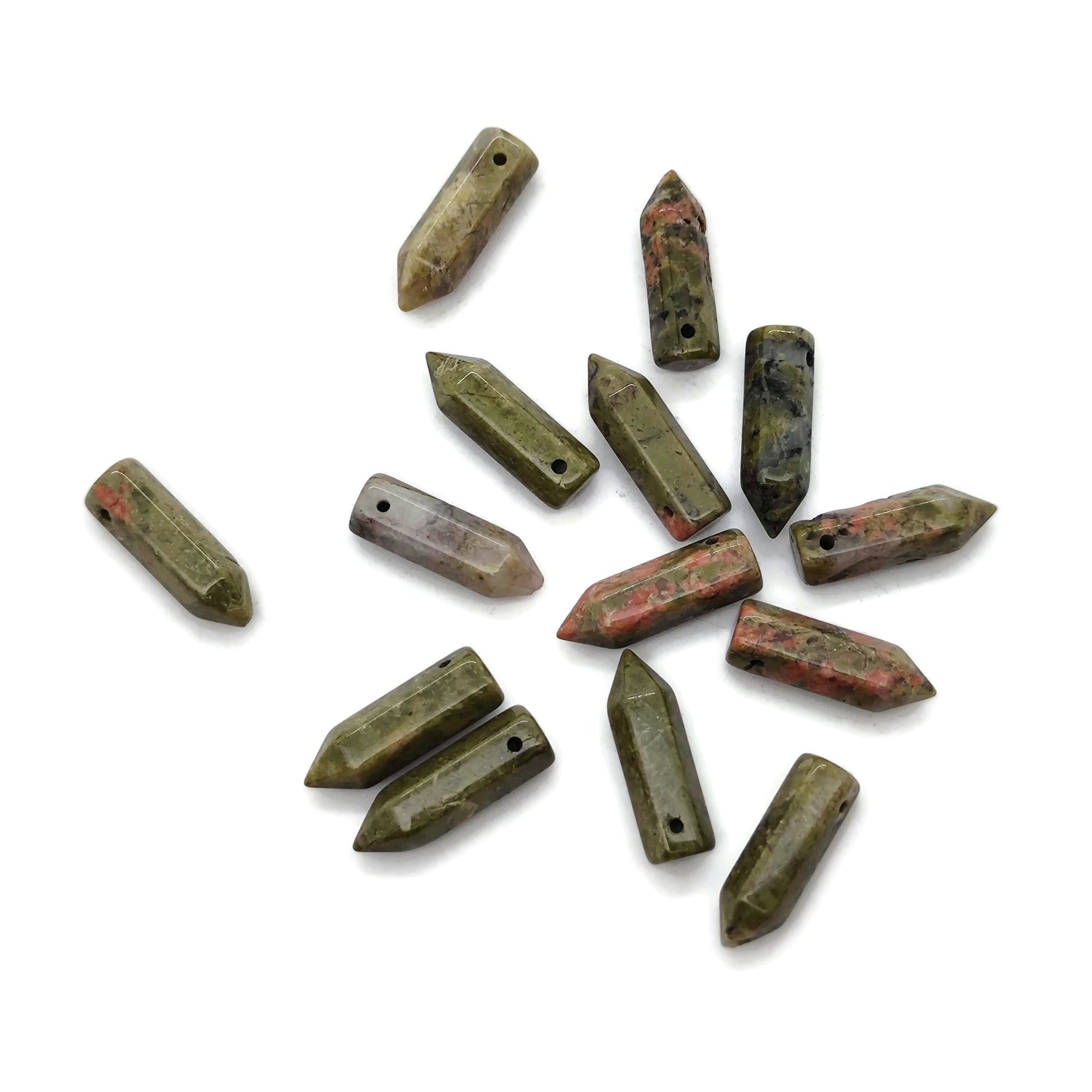 Unakite point hole crystal pendant from GemstoneGO showing a drilled green and pink gemstone crystal pendant on a white background.