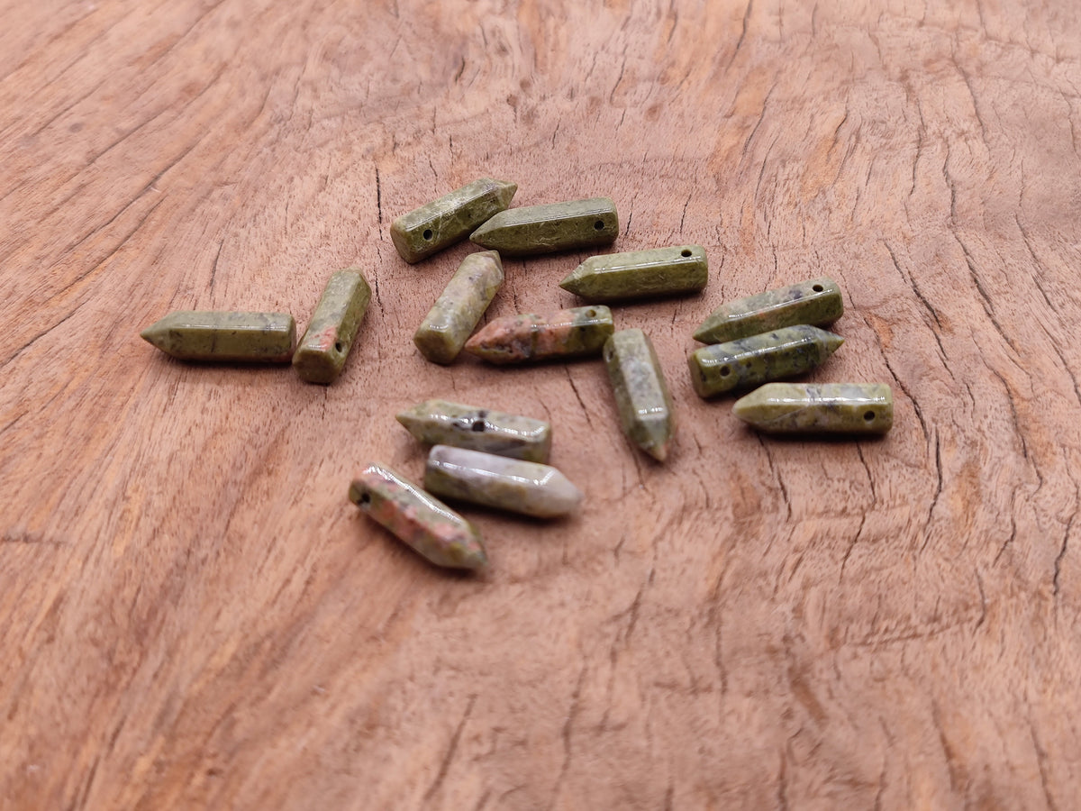 Unakite point hole crystal pendant from GemstoneGO, featuring a drilled natural gemstone with a smooth, polished surface.