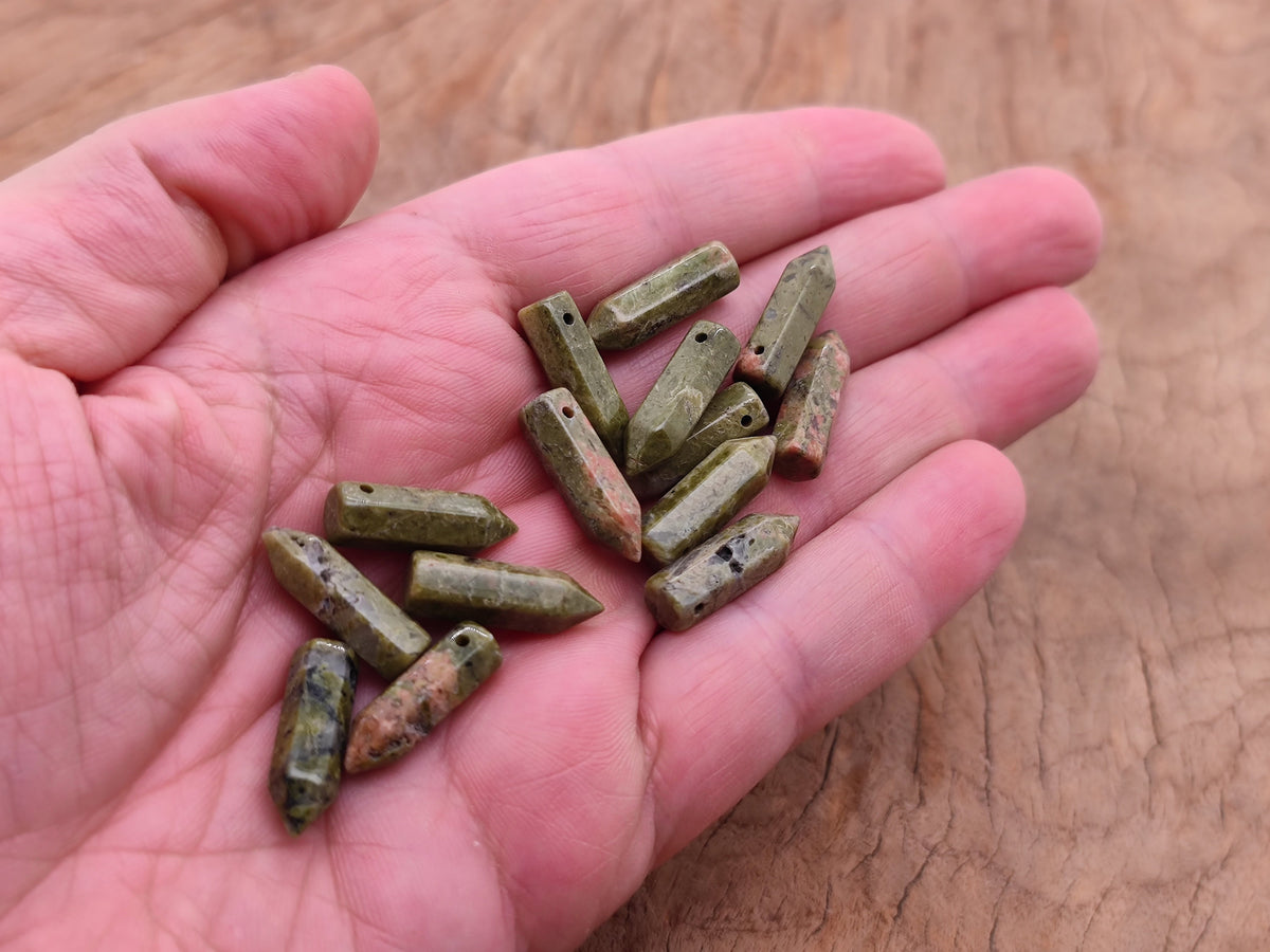 Unakite crystal point pendant with drilled hole, featuring natural green and pink mineral patterns, by GemstoneGO.