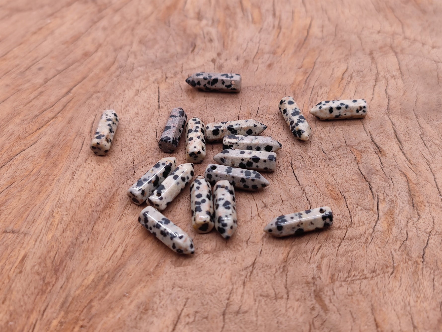 Dalmatian Jasper crystal point pendant with drilled hole, featuring black and cream spotted gemstone from GemstoneGO.
