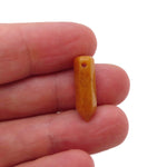 Yellow jade crystal pendant with drilled point, showcasing a vibrant, polished gemstone with natural color variations.