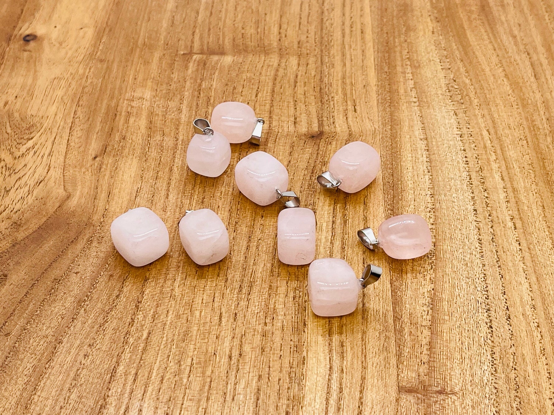 Rose quartz tumbled gemstone pendant from GemstoneGO, featuring a smooth pink polished stone on a simple bail.