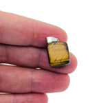 Tiger Eye tumbled gemstone pendant from GemstoneGO, showcasing a smooth, polished, golden-brown stone on a simple cord.
