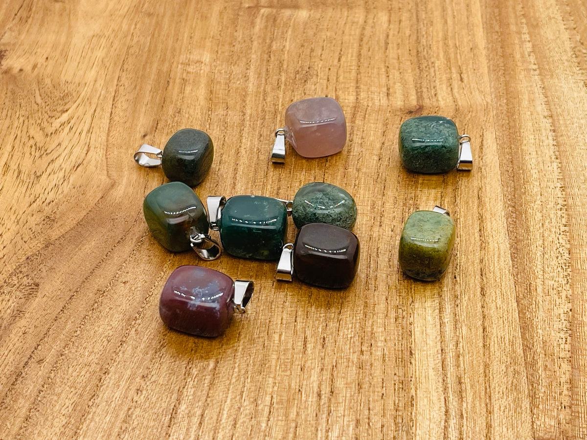 Moss agate tumbled crystal pendant from GemstoneGO featuring a natural green and brown stone on a silver chain.