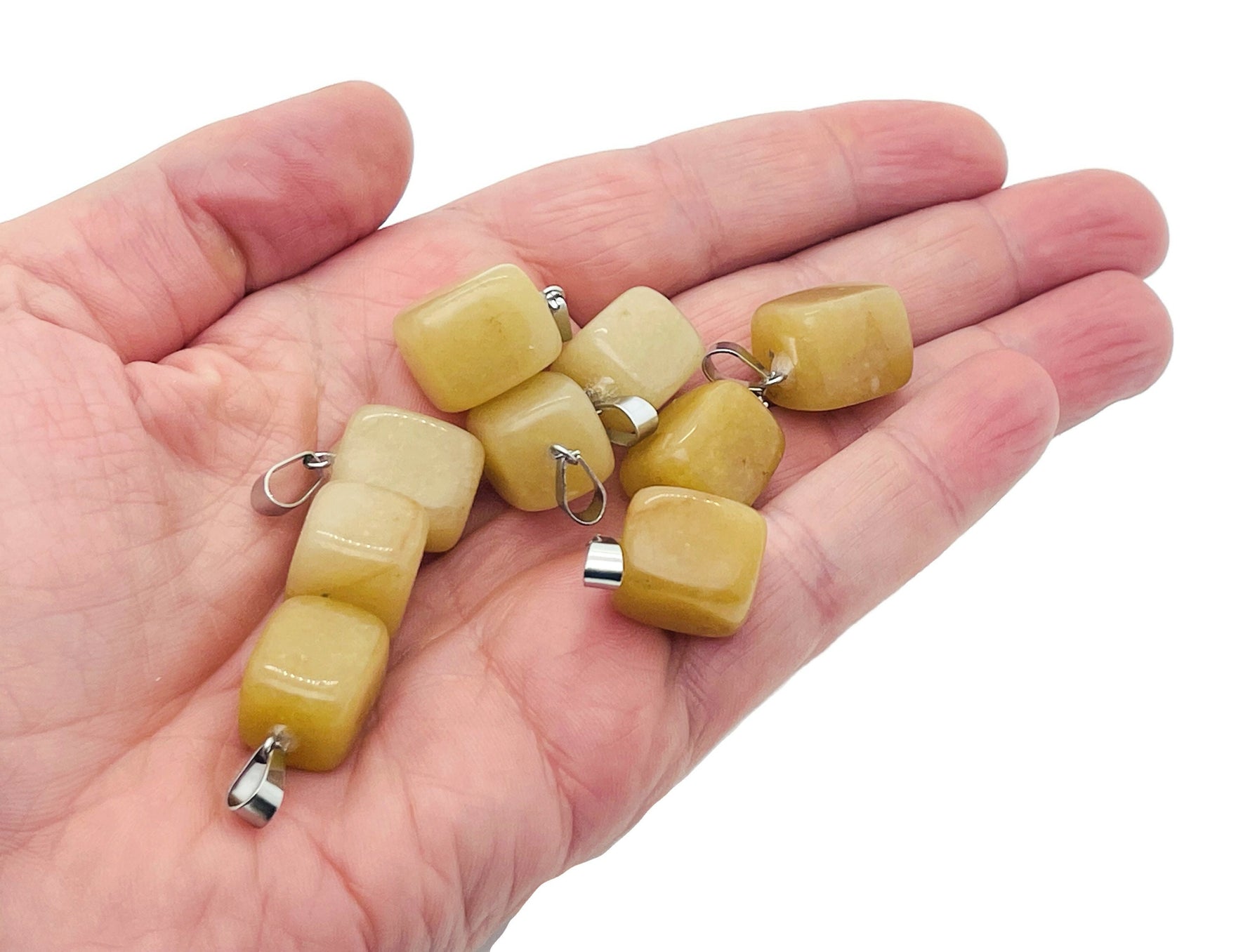 Yellow jade tumbled gemstone pendant from GemstoneGO with smooth, polished surface and natural yellow color.