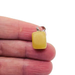 Yellow jade gemstone pendant from GemstoneGO, featuring a smooth tumbled yellow jade stone on a simple metal bail.