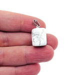 Smooth Howlite tumbled gemstone pendant from GemstoneGO, showcasing a polished, light gray stone with subtle veining.