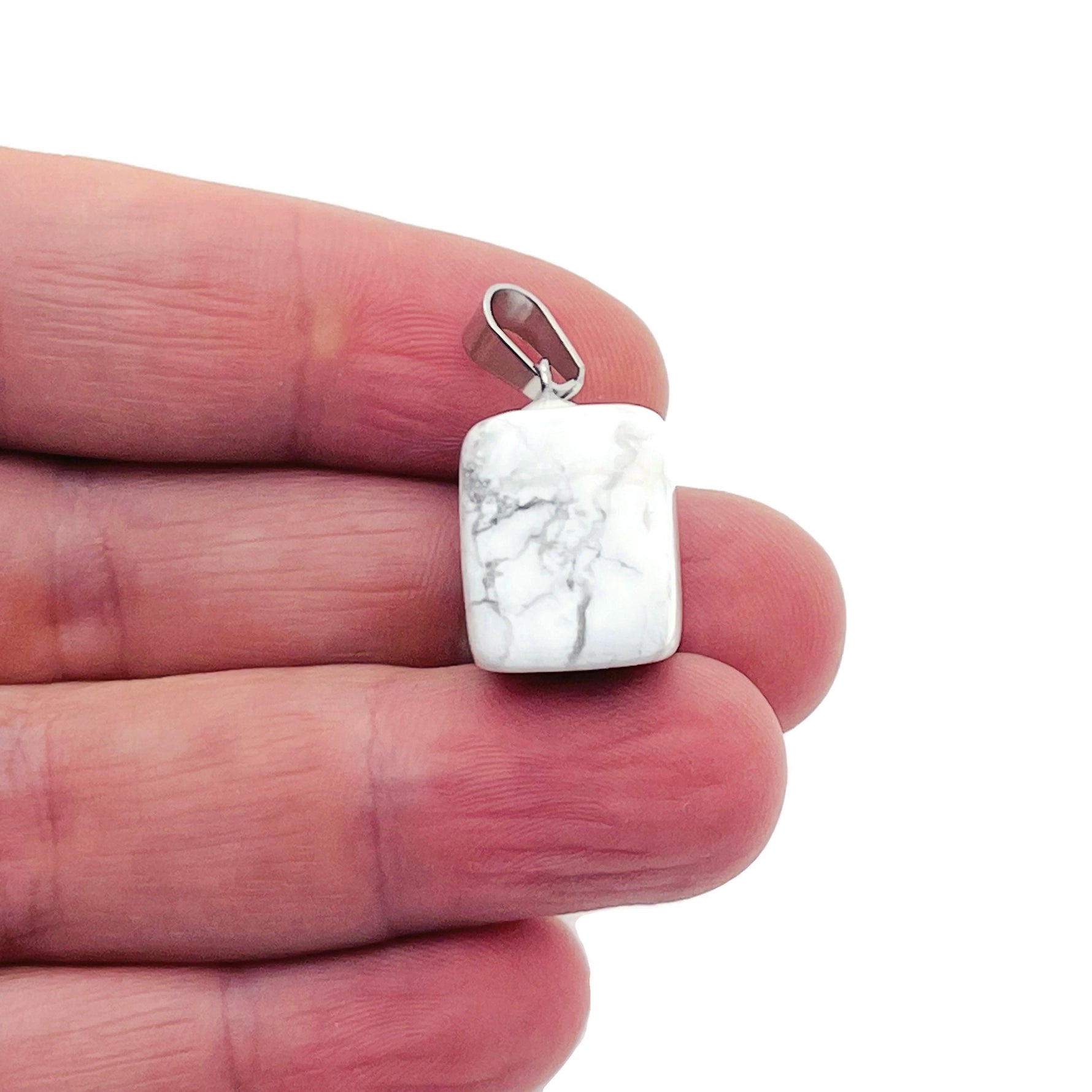 Smooth Howlite tumbled gemstone pendant from GemstoneGO, showcasing a polished, light gray stone with subtle veining.