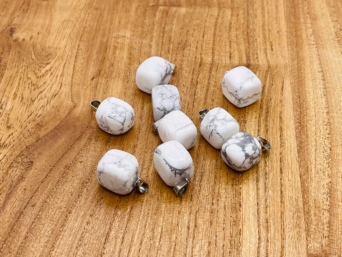 Smooth white Howlite tumbled gemstone pendant from GemstoneGO featuring a polished, natural stone with soft gray veining.