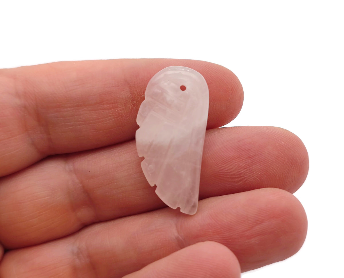 Rose quartz crystal angel wing pendant featuring carved angel wing design, gemstone jewelry with charm details.