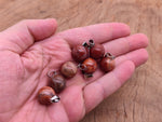 Red Jasper crystal ball pendant from GemstoneGO, showing a polished round gemstone used for jewelry making.