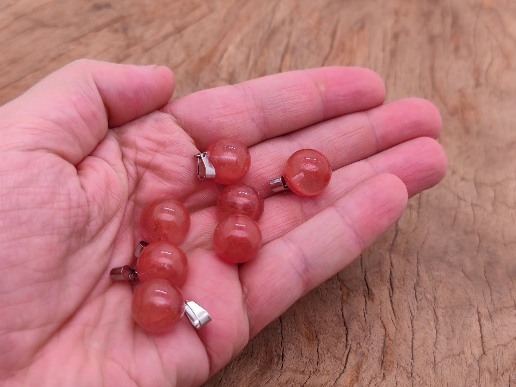 Cherry Quartz ball crystal pendant from GemstoneGO, showcasing a smooth round gemstone suitable for jewelry making.