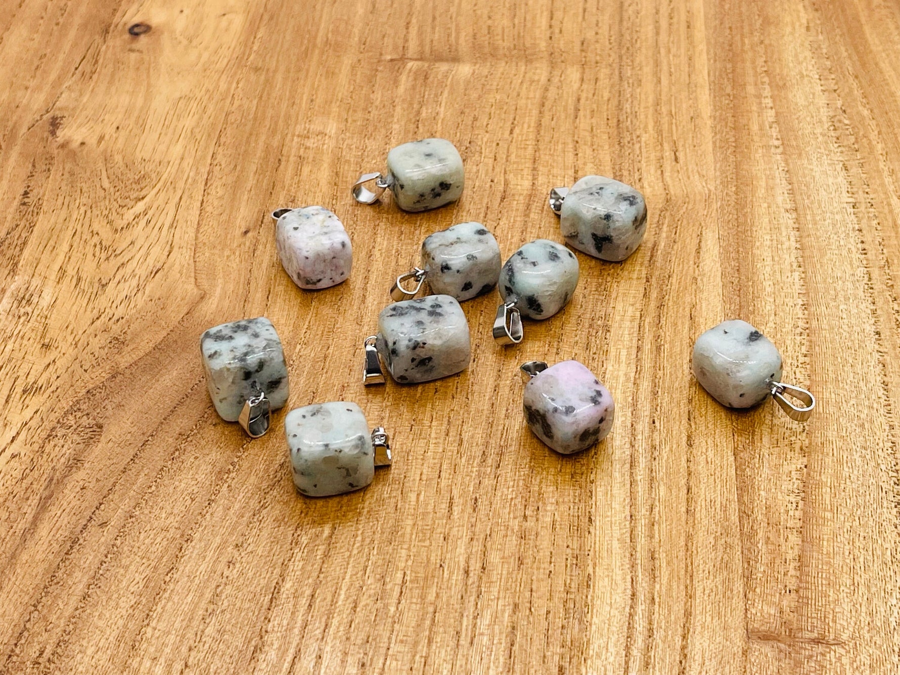 Close-up of a Kiwi Jasper tumbled crystal pendant featuring a natural love stone from GemstoneGO, showcasing its vibrant green and earthy tones.