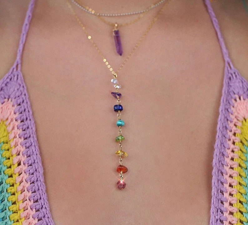 Silver and gold 7 chakra crystal necklace featuring colorful gemstone beads arranged in a layered pendant design.