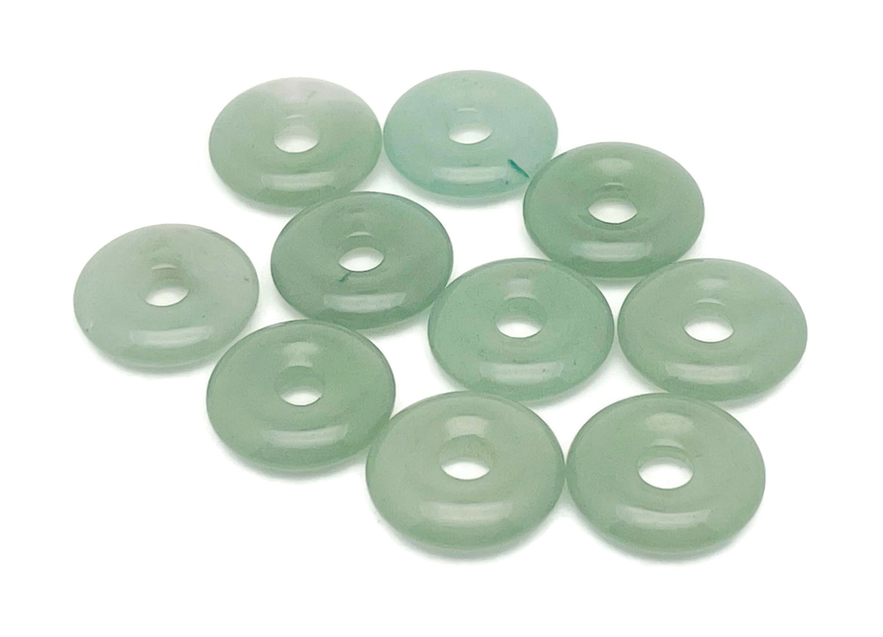 A 20mm aventurine crystal donut pendant with natural green gemstone, featuring a polished, rounded shape and intricate surface details.