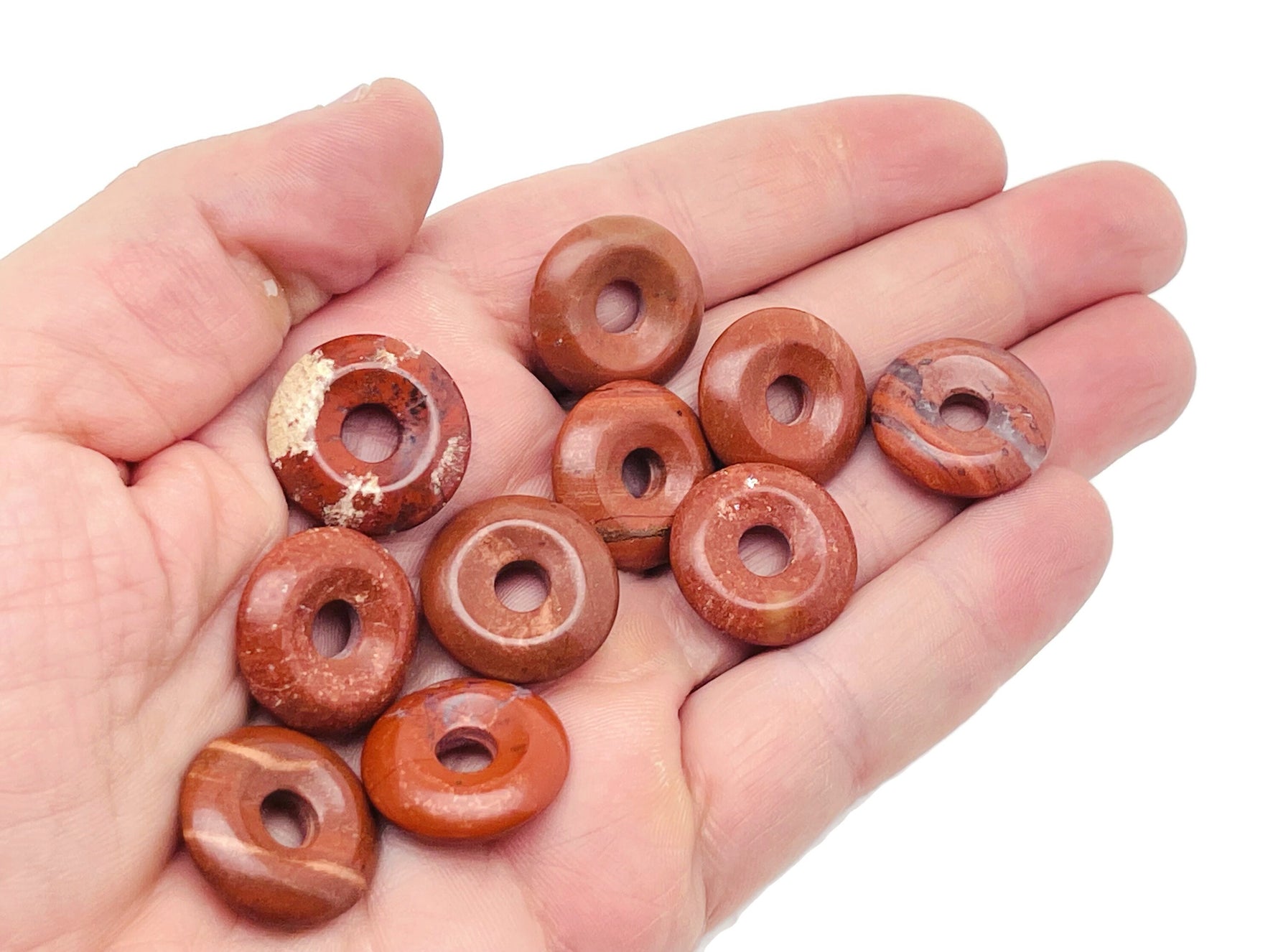 Red Jasper crystal donut pendant from GemstoneGO, 20mm Pi Stone with polished red jasper stone and smooth, rounded shape.
