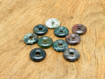 Moss agate crystal donut pendant from GemstoneGO, 20mm Pi stone with intricate green and brown moss patterns.