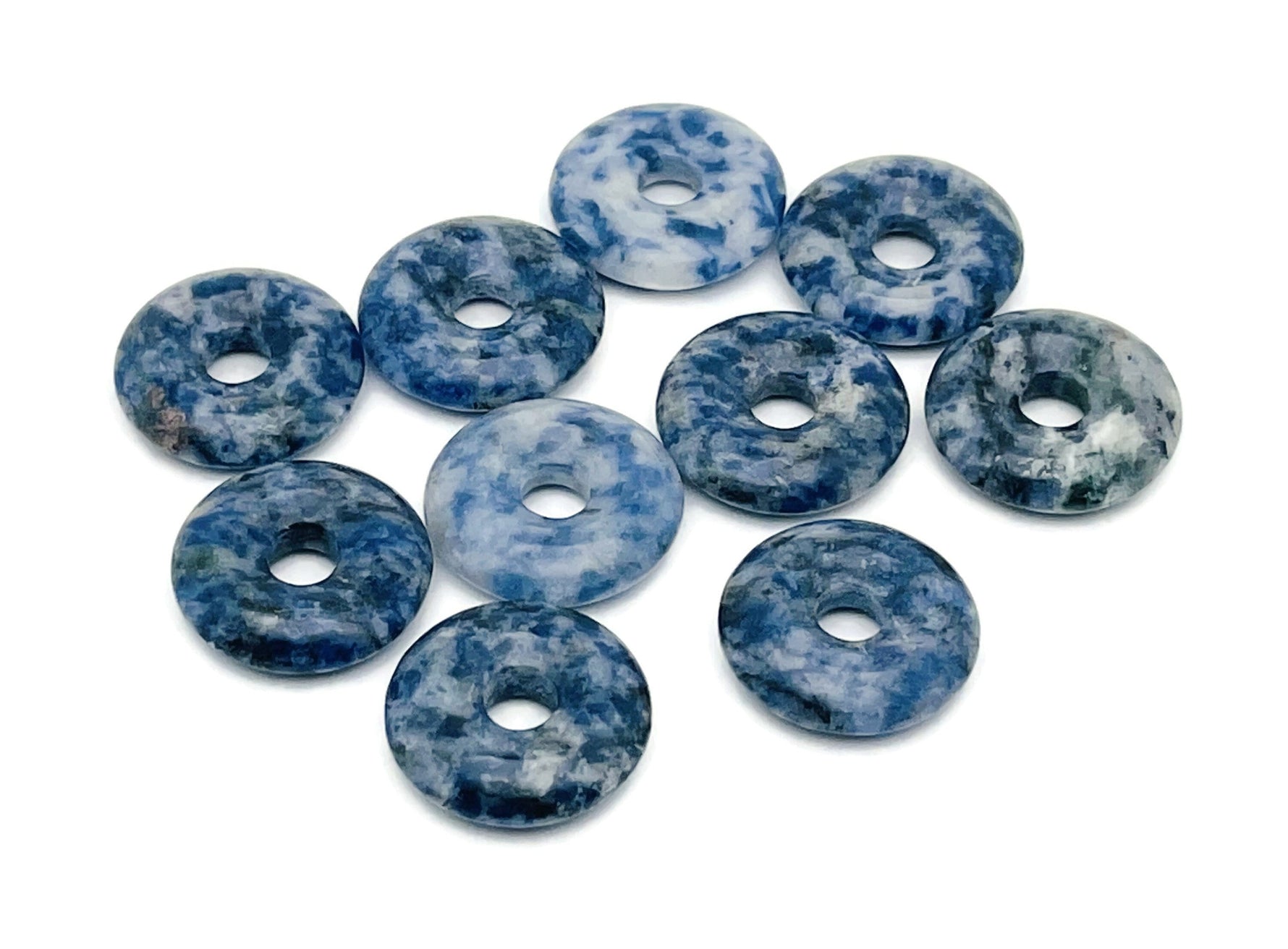 Blue Spot Jasper crystal donut from GemstoneGO, 20mm Pi Stone with vibrant blue spots and polished surface.