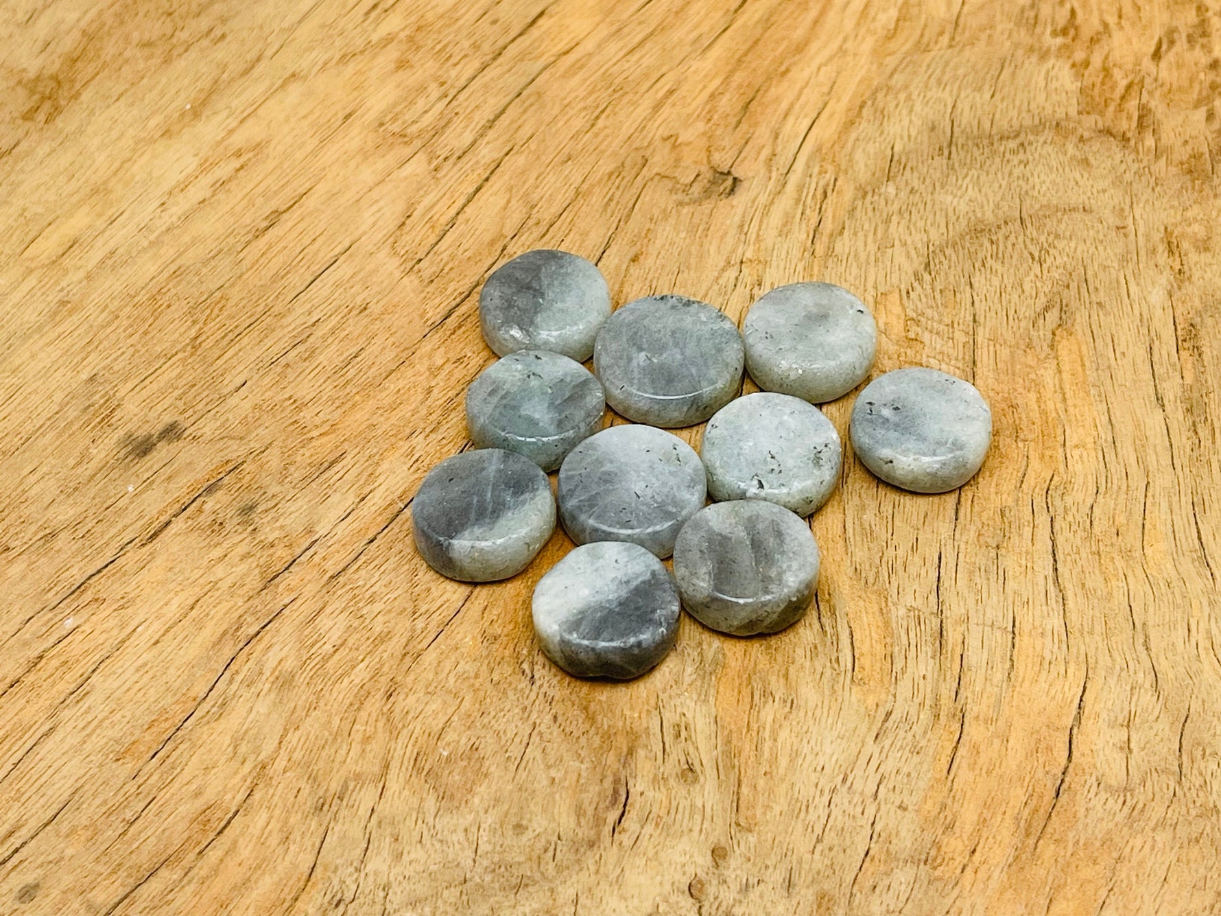 Round Labradorite flat gemstone slab from GemstoneGO showcasing iridescent blue and green hues in a polished stone.