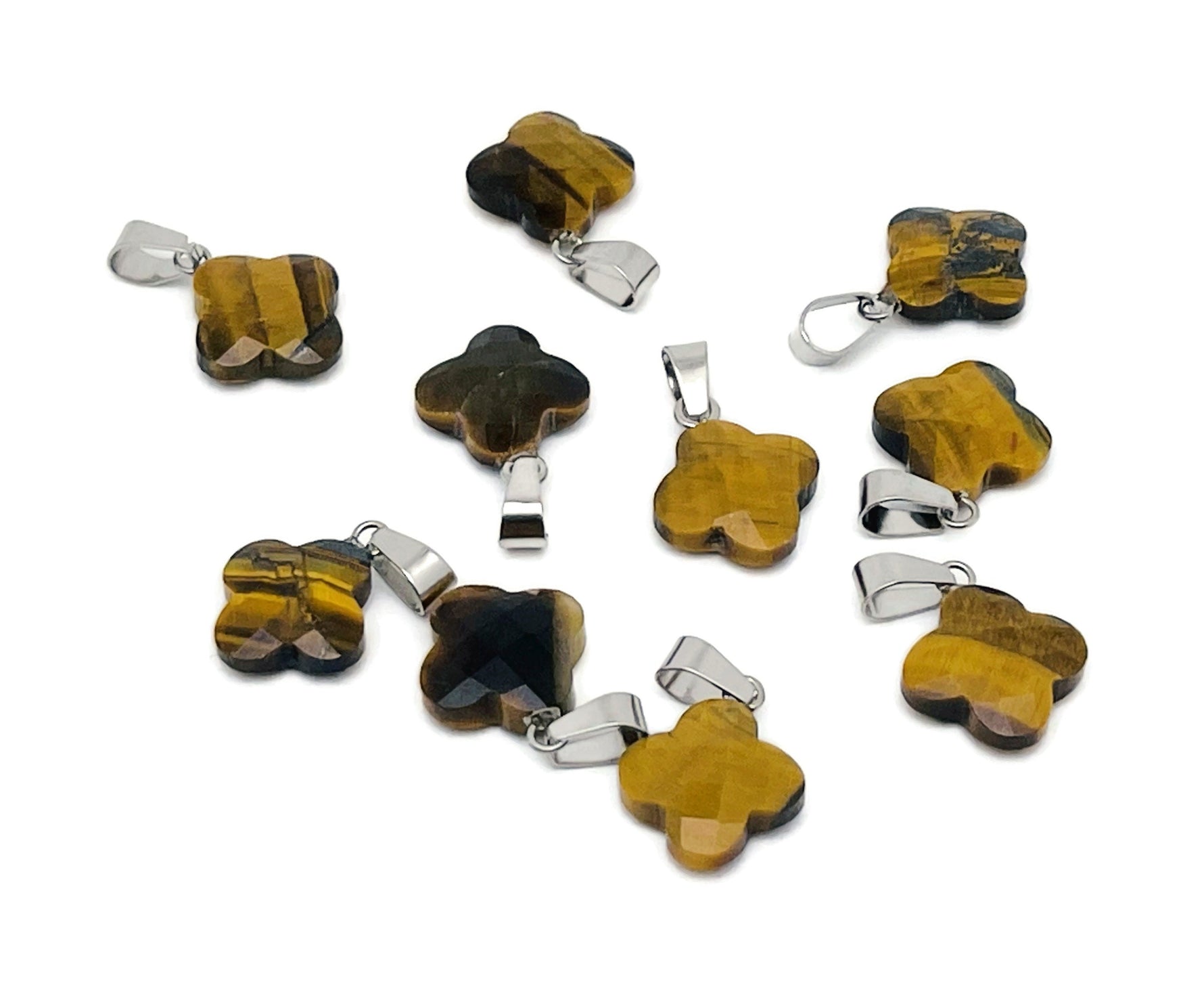 Tiger Eye four-leaf clover crystal pendant from GemstoneGO, showcasing a polished gemstone pendant for DIY jewelry making.