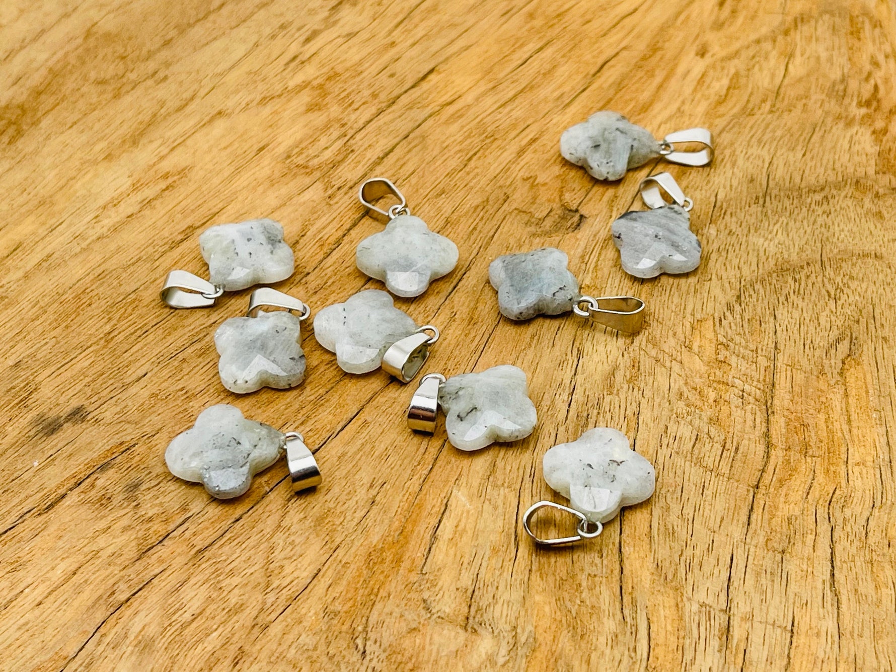 Labradorite four-leaf clover crystal pendant from GemstoneGO, showcasing a polished gemstone with a silver setting for jewelry making.