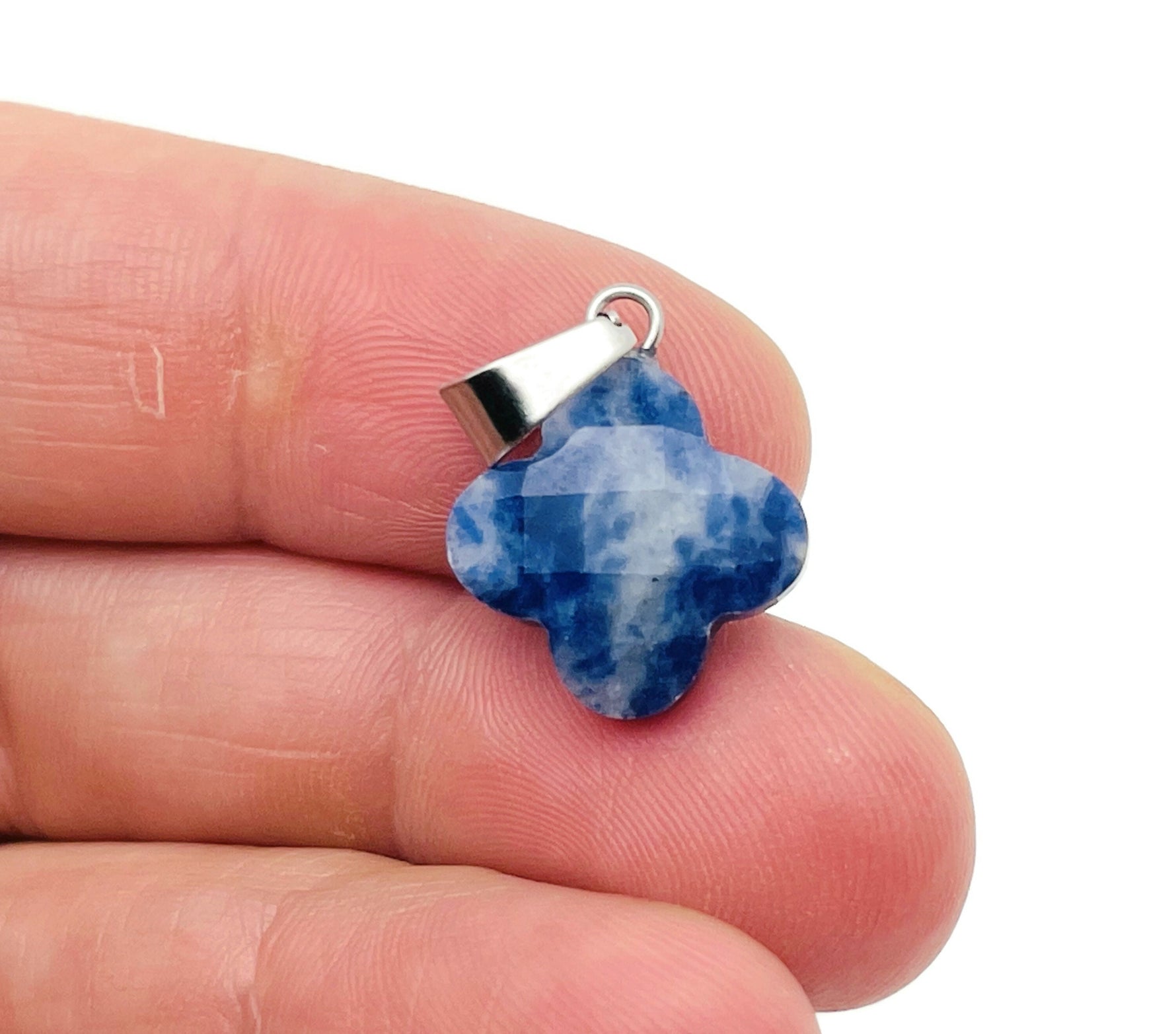 Blue sodalite four-leaf clover crystal pendant for DIY jewelry making, featuring a polished gemstone with a silver bail.