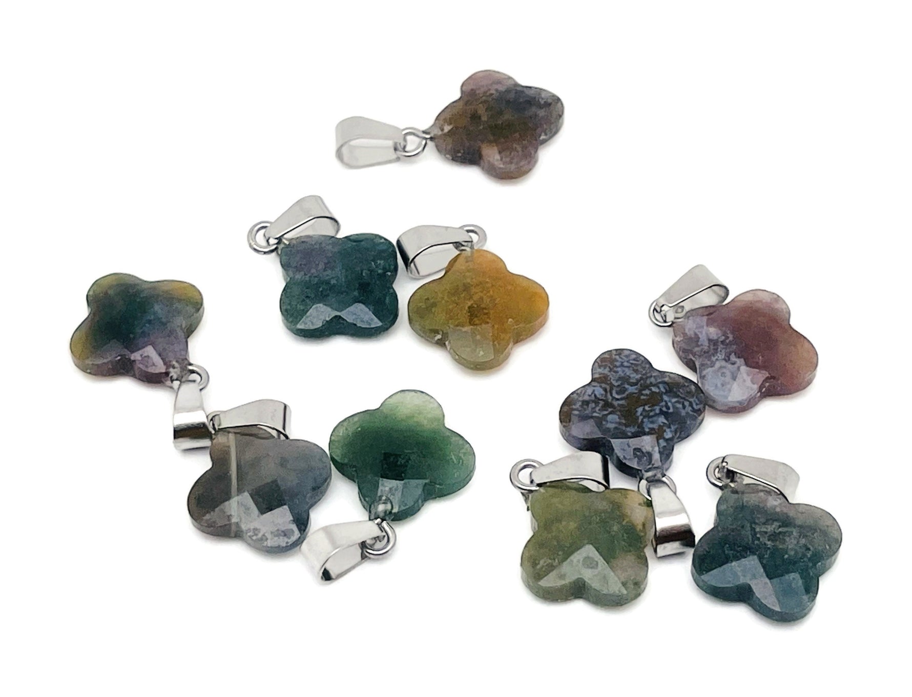 Moss agate four-leaf clover crystal pendant from GemstoneGO, showcasing the detailed green and brown stone with a silver bail.