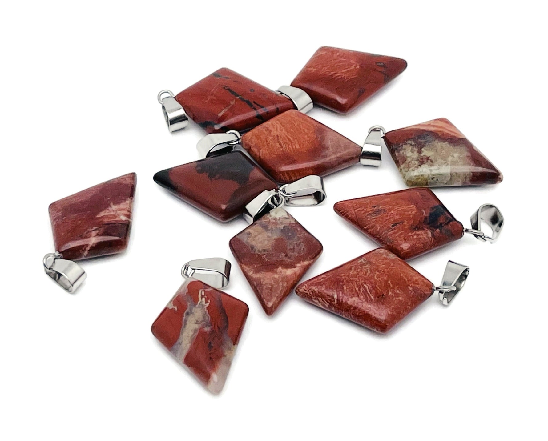 Red Jasper triangle gemstone pendant with geometric design from GemstoneGO, showcasing a polished red gemstone on a silver setting.