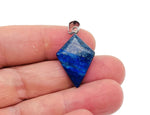 Lapis Lazuli triangle gemstone pendant with geometric design from GemstoneGO, showcasing deep blue color and polished surface.