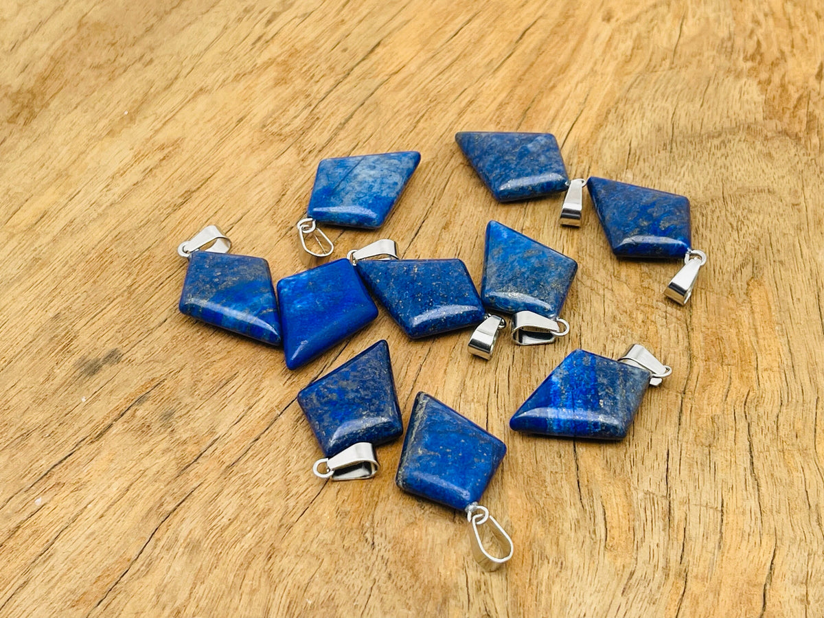 Lapis Lazuli triangle gemstone pendant with geometric design, crafted by GemstoneGO, showcasing deep blue and gold flecks.