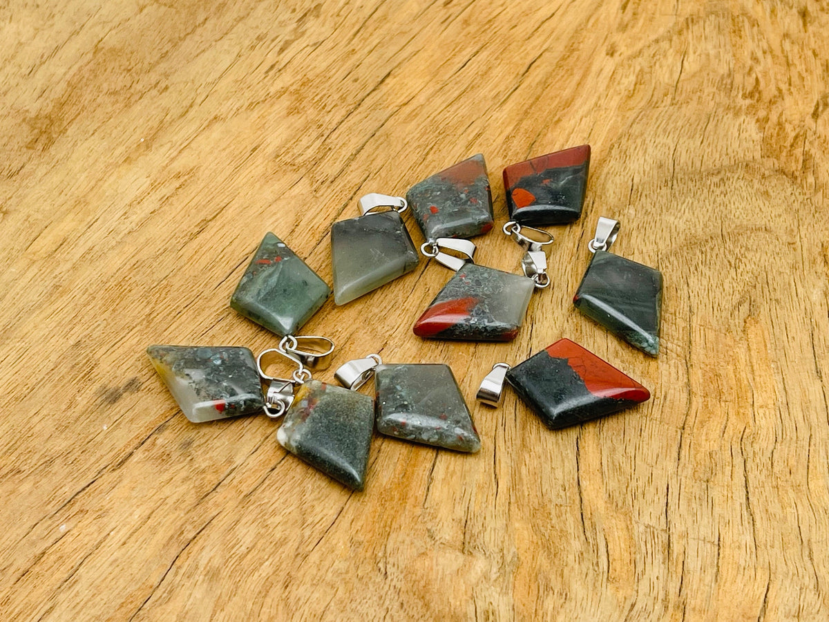 African Bloodstone triangle gemstone pendant with geometric design, featuring a polished bloodstone gemstone on a silver chain.