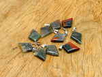 African Bloodstone triangle gemstone pendant with geometric design, featuring a polished bloodstone gemstone on a silver chain.