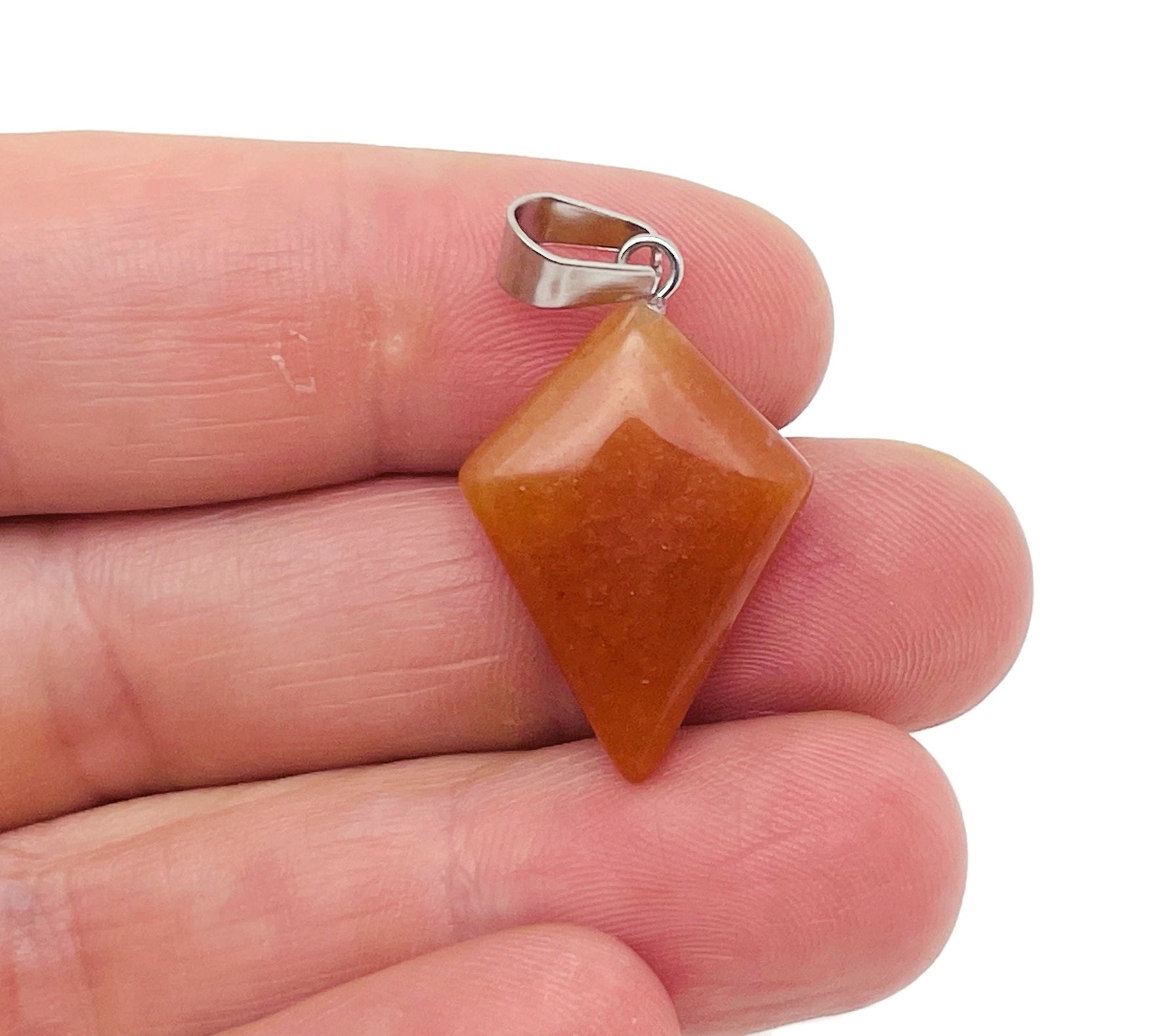 Orange aventurine triangle gemstone pendant from GemstoneGO featuring a geometric design on a silver chain.