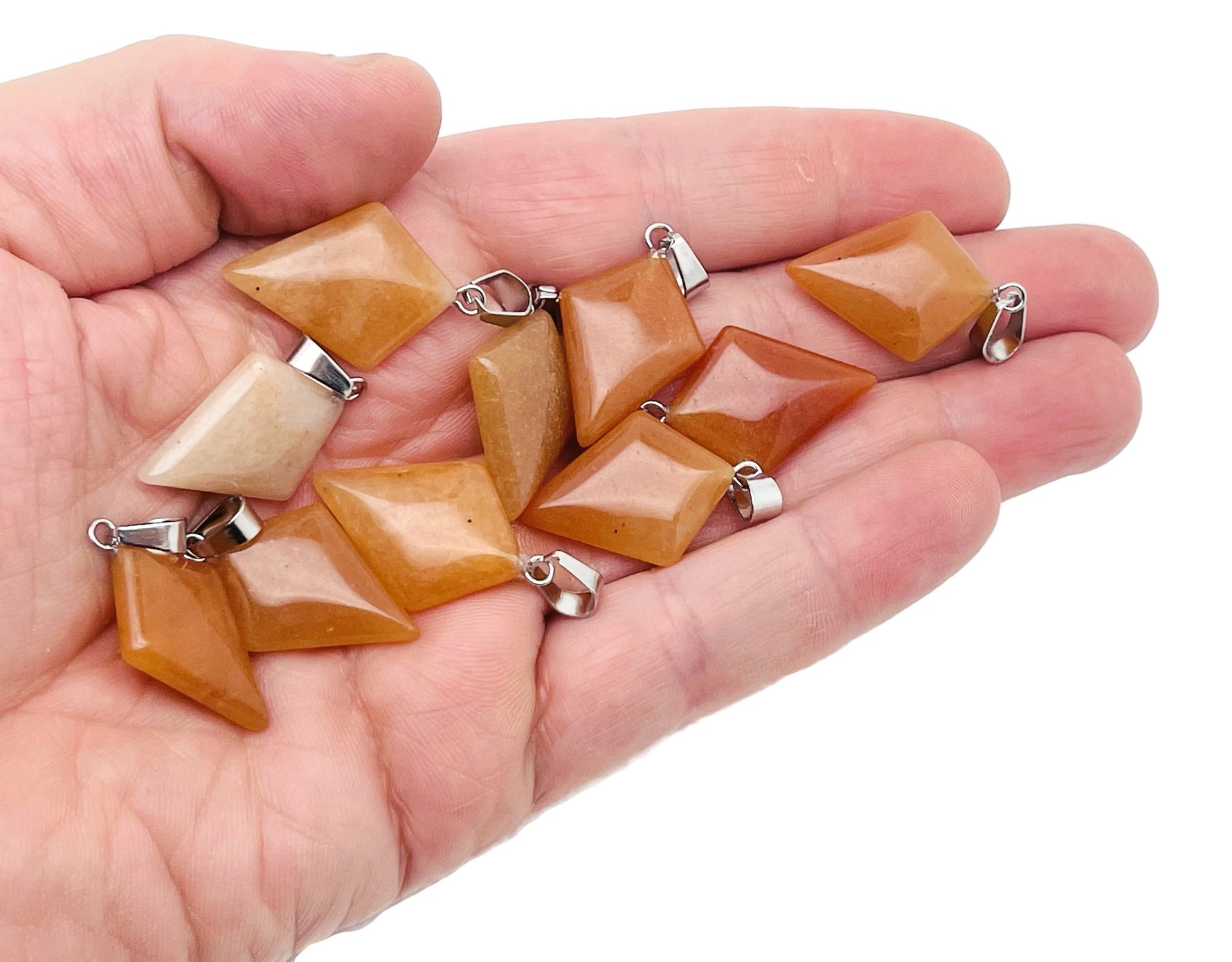 Orange aventurine triangle gemstone pendant from GemstoneGO, featuring a geometric design and polished finish.