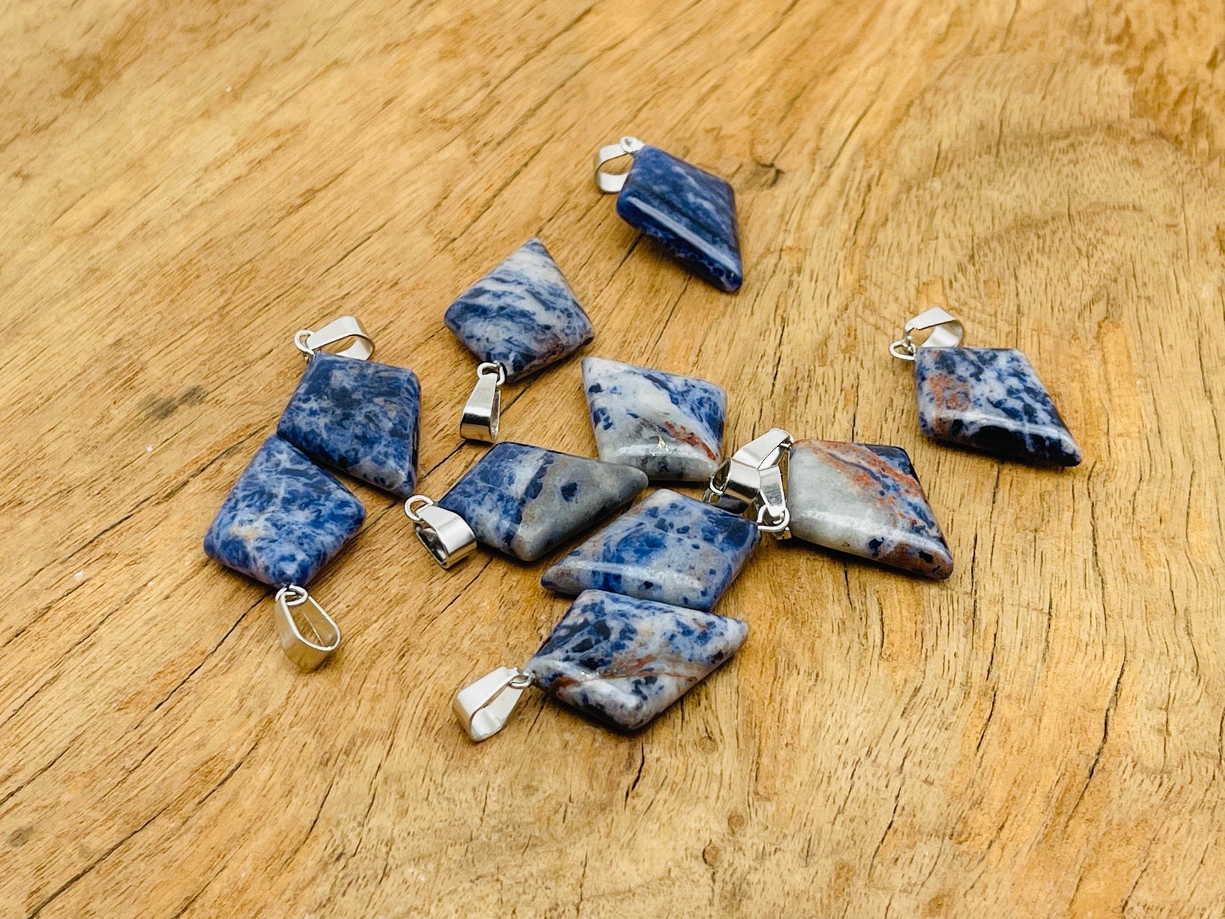 Sodalite triangle gemstone pendant by GemstoneGO featuring a geometric design and vibrant blue color.