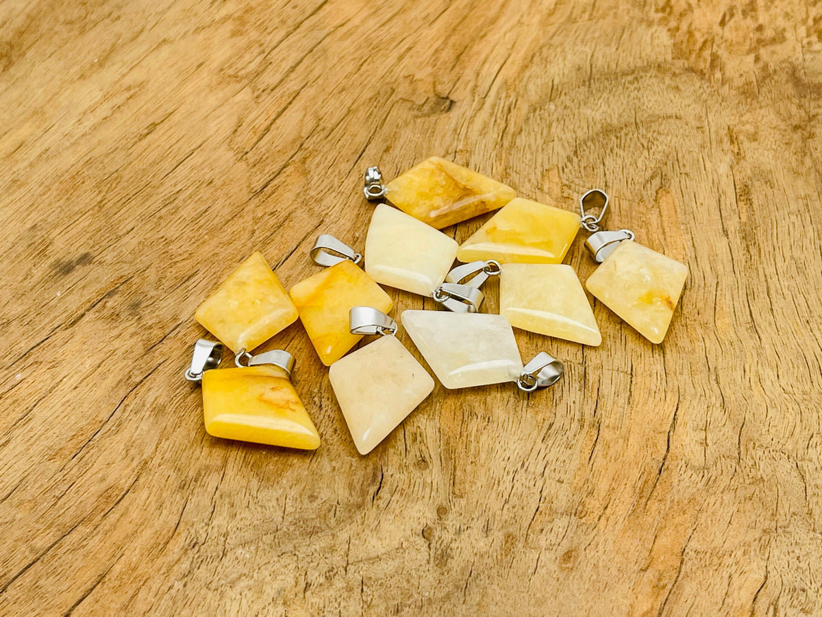 Yellow jade triangle gemstone pendant with geometric design, crafted by GemstoneGO, showcasing a polished, vibrant yellow stone.
