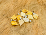 Yellow jade triangle gemstone pendant with geometric design, crafted by GemstoneGO, showcasing a polished, vibrant yellow stone.