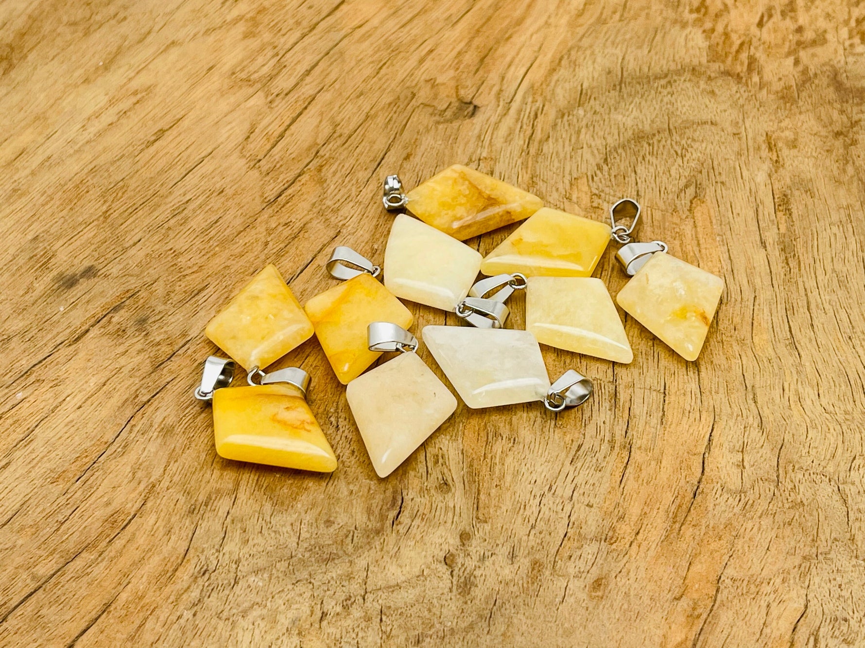 Yellow jade triangle gemstone pendant with geometric design, crafted by GemstoneGO, showcasing a polished, vibrant yellow stone.