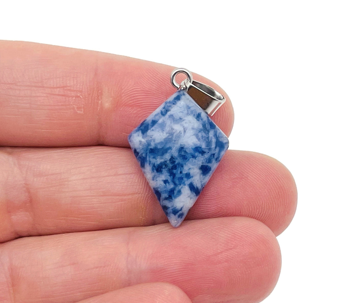 Blue Spot Jasper triangle gemstone pendant with geometric design, showcasing vibrant blue and natural stone details.