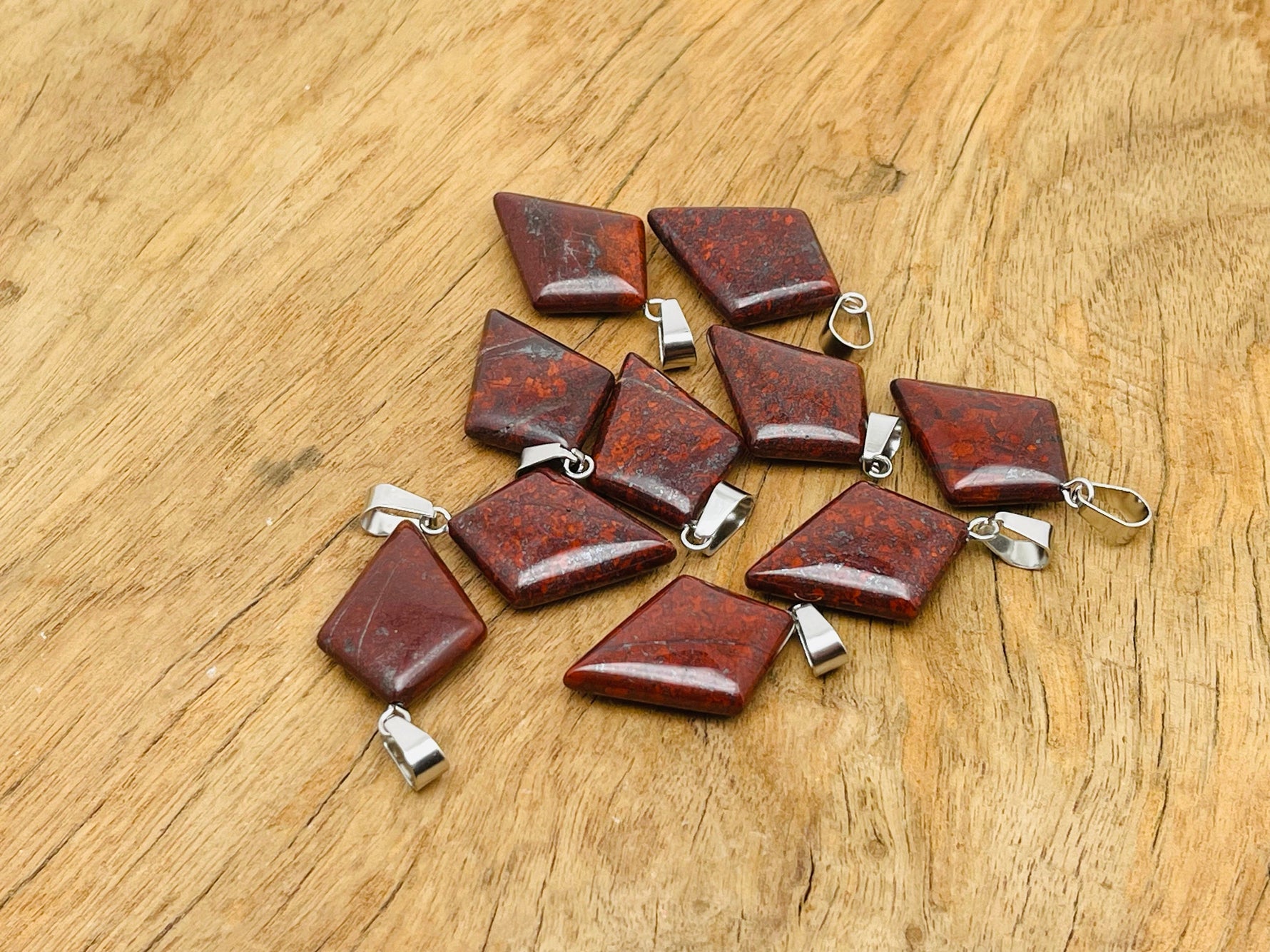 Chicken Bloodstone Jasper pendant featuring a geometric triangle shape, showcasing rich red and green tones in a natural gemstone.